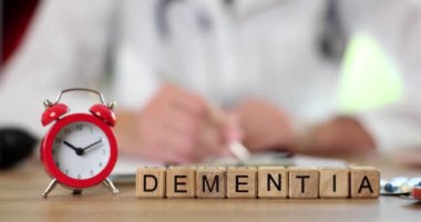 Dementia inscription on wooden cubes, close-up, slowmotion. Elderly disease, treatment. Violation of memory