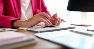 A woman in the office prints on a wireless keyboard, a close-up, slowmotion. The workplace of the entrepreneur