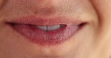 Macro female smiling mouth, slowmotion. White teeth, natural lips, without cosmetics, positive emotions
