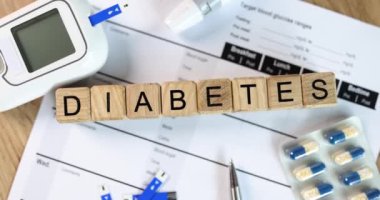 Diabetes inscription on wooden cubes on the doctor table, close-up. Tools and medicines for insulin resistance