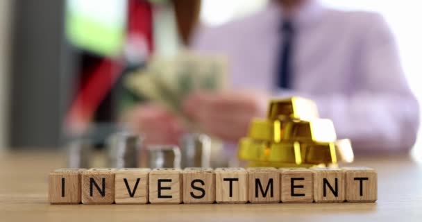 Investment Inscription Wooden Cubes Table Close Slowmotion Investor Considers Money — Stock video