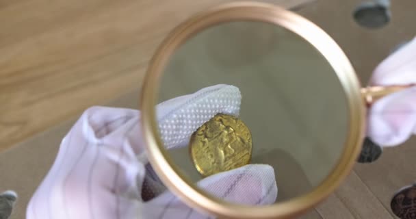 Hands Gloves Hold Old Coin Magnifying Glass Close Estimated Value — Video Stock