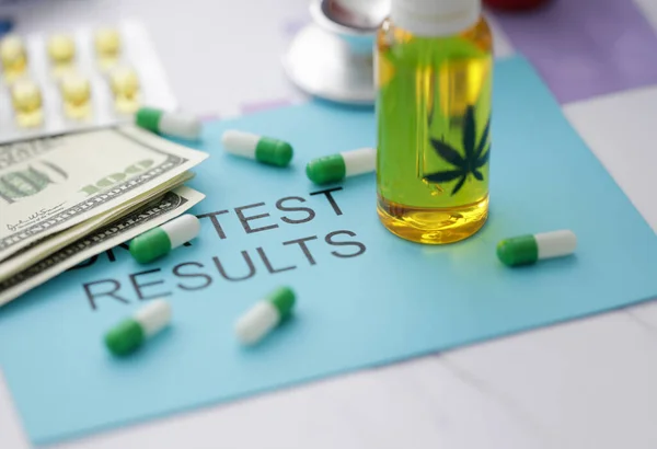 stock image Pills jar of marijuana oil on blue envelope with inscription test result.