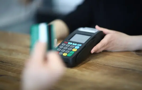 Digital Paying for Service via Payment Terminal. Hand with Credit Card Swipe on Machine. Electronic Money Transaction Checkout. Using Technology Device for Financial Operation Close-up Photography