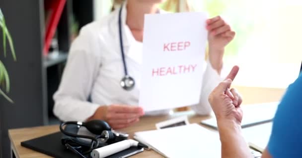Doctor Holds Inscription Bless You Patient Shows Fuck You Patient — стоковое видео
