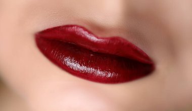 Güzel kırmızı dudakların yakın çekimi. Profesyonel tatil akşam maquillage. Baştan çıkarıcı kadın ağzının parlak rengi. Güzellik makyaj ve kozmetik konsepti