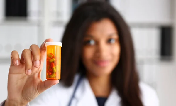Female black doctor hands hold jar of pills closeup. Panacea life save healthy lifestyle prescribe treatment legal drug store contraception concept