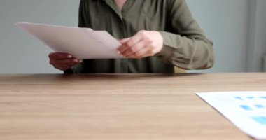 İş kadını çalışma ve analiz için 4K film üzerinde grafikleri olan bir sürü belge hazırlıyor. İş geliştirme okulu finansal büyüme kavramı