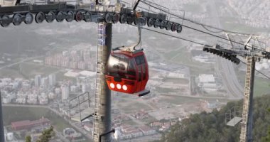 Cabin descends cable car with beautiful cityscape. Above the clouds and sightseeing rope travel travel concept