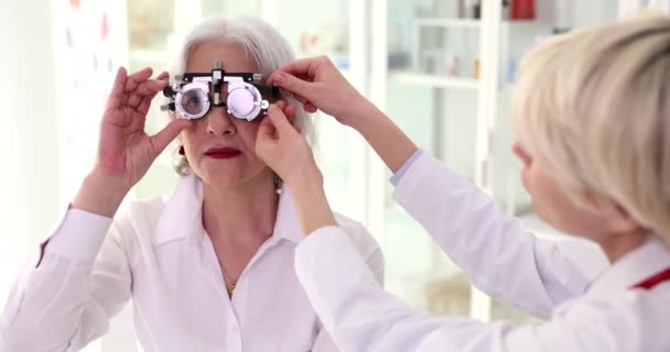 Läkare Oftalmolog Sätta Glasögon För Att Kontrollera Synen Till Äldre — Stockvideo
