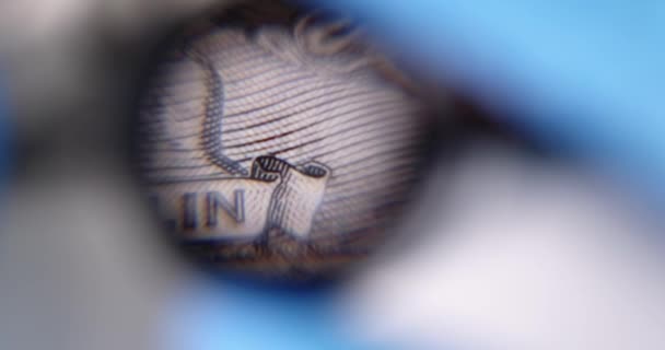 Άτομο Εξετάζει Χαρτονόμισμα Των 100 Δολαρίων Μέσα Από Μεγεθυντικό Φακό — Αρχείο Βίντεο