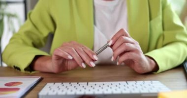 Businesswoman knocking with pen on hands and getting nervous closeup 4k movie slow motion. Making important business decisions concept