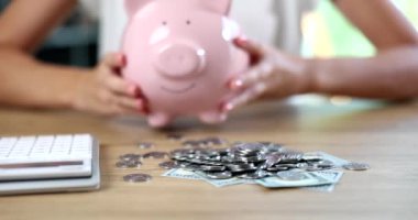Female hands putting piggy bank on table in front of money closeup 4k movie slow motion. Family budget concept