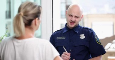 Male police officer interrogating woman at home 4k movie slow motion. Police emergency concept