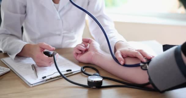 Doctor Measuring Blood Pressure Man Patient Using Tonometer Closeup Movie — Stockvideo