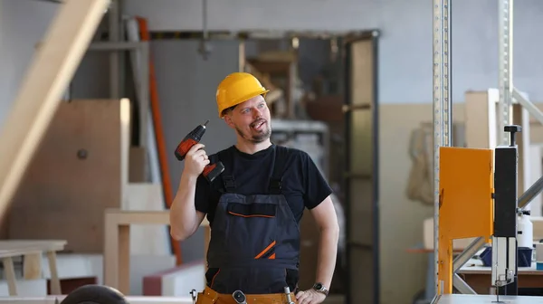 Idiot worker using electric drill portrait. Manual job DIY inspiration improvement fix shop yellow helmet joinery startup idea industrial education profession career concept