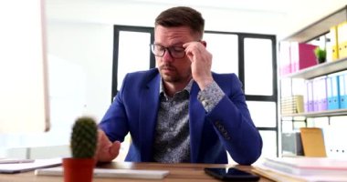 Bilgisayarda yazı yazmaktan ve gözlüğünü çıkarmaktan bıkmış bir işadamı. Aşırı çalışma ve alışveriş konsepti