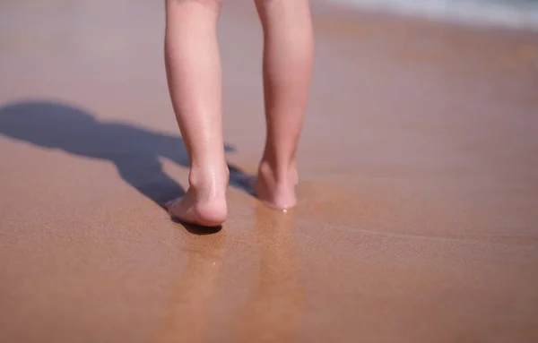 Wet bare feet walk along beach along sea. Keep calm on vacation and being alone concept