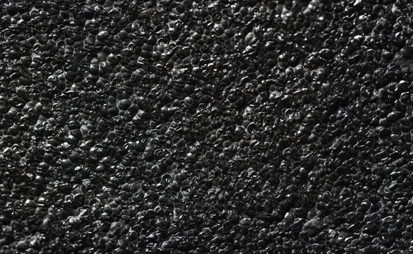 Black rough concrete gravel wall background texture. Black abstract concept