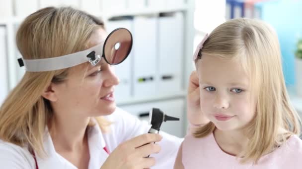 Ent女人用耳镜看小女孩的耳朵 儿童耳疾概念 — 图库视频影像