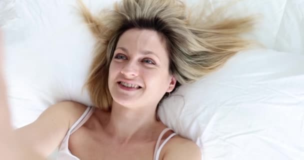 Happy Woman Takes Selfie While Lying Bed Close Hand Held — Stock video