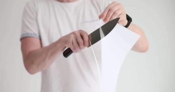 Man Cuts White Paper Sharp Knife Close Concept Cause Pain — Stock Video