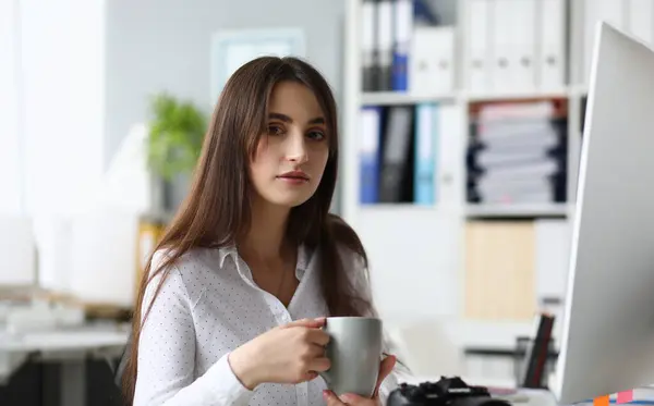 Portrait of peaceful woman designing interest project. Beautiful businesswoman looking at camera with calmness. Business and art design concept. Blurred background