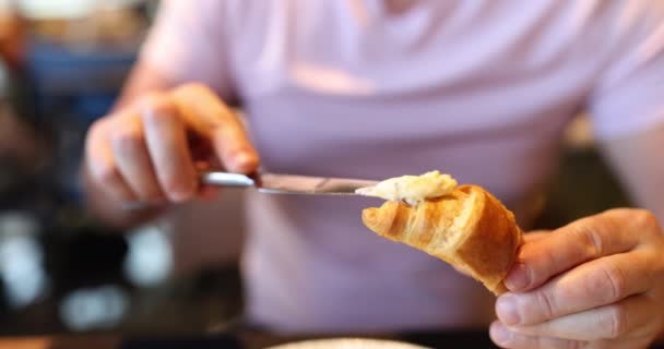 전통적 아침으로 크로와 만들고 버터를 퍼뜨린다 카페에서 아침이나 점심을 — 비디오