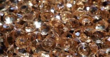 Yellow shiny diamonds and gems. Examination of quality of jewelry and diamonds concept
