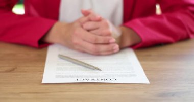 Female hands of lawyer agent or business partner with contract and pen. Signing and conclusion of contract