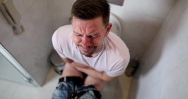 Man with problems in toilet constipation and diarrhea. Food poisoning symptoms in adult