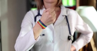 Woman doctor with lgbt bracelet on arm in clinic. Gay nurse or doctor and transgender medical support