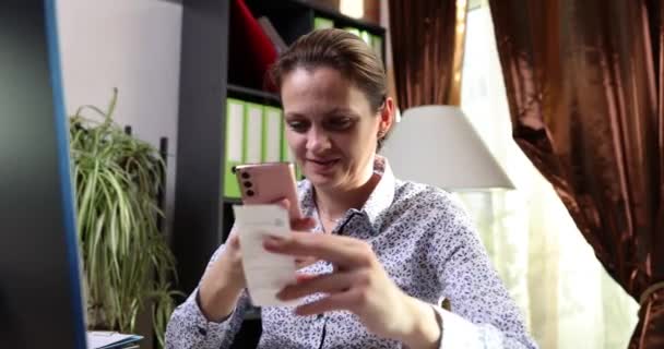 Smiling Woman Scanning Two Dimensional Code Using Mobile Phone Online — Stock video