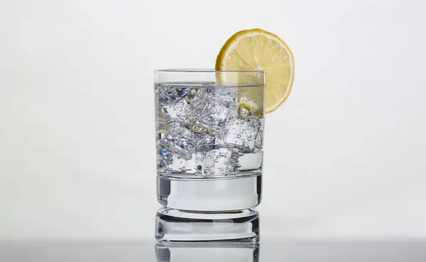 Glass with water and lemon. Lemon water for body health concept