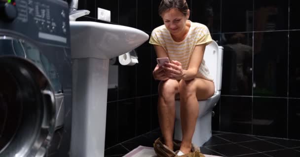 Woman Using Phone While Sitting Toilet Bathroom Home Smartphone Addiction — Stockvideo
