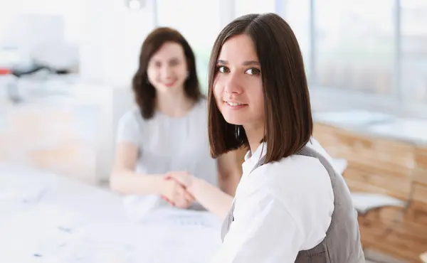Businesswoman and woman shake hands as hello in office closeup. Friend welcome introduction greet or thanks gesture product advertisement partnership approval arm strike a bargain on portrait concept