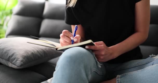 Woman Writes Notebook Journal Diary Pen Sits Sofa Relaxing Home — Stock Video