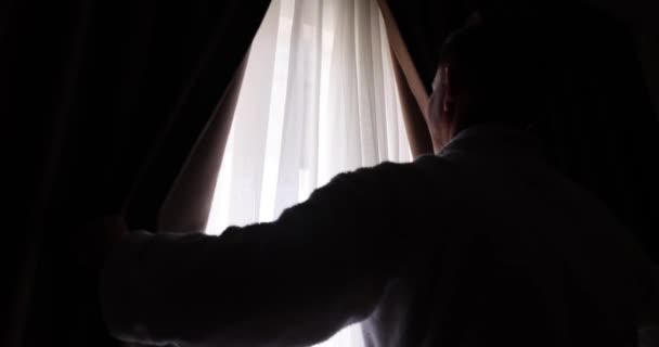 Man Opens Dark Curtains Look View Beginning New Day Brighter — Stock Video