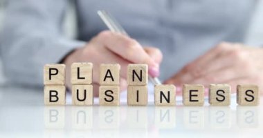 Businessman plans and draws up business plan for development of company. Marketing plan development and financial growth concept