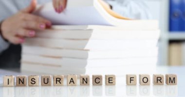 Insurance agent is looking for client insurance form. Insurance form archive and paperwork concept