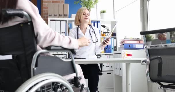 Professional Doctor Consults Patient Wheelchair Checks Ray Spinal Injury Treatment — Stock Video