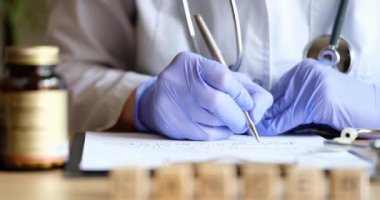 Doctor or pharmacist writes prescription on special form sitting at desk. Medical care pharmacy or health insurance