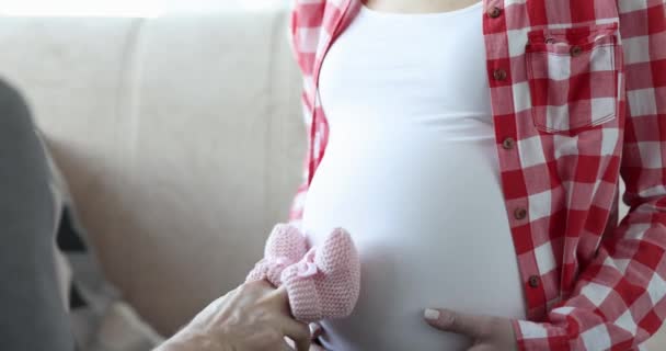 Man Holds Pink Newborn Slippers Stomps Belly Pregnant Woman Parents — Stock videók