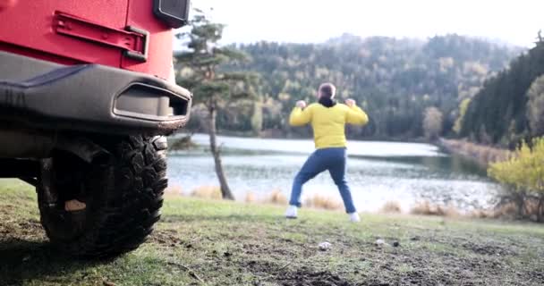 Glückliche Männliche Reisende Springen Der Nähe Des Schönen Bergsees Zurück — Stockvideo