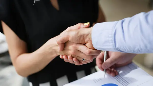 Businesswoman and woman shake hands as hello in office portrait. Friend welcome introduction greet or thanks gesture product advertisement partnership approval arm strike bargain on deal concept