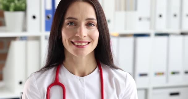 診療所で白衣を着た若い女性医師の肖像画 専門職の概念の選択 — ストック動画