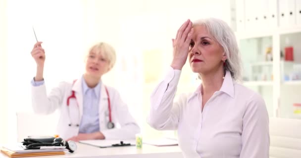 医生检查老年女性病人的视力 在诊所4K电影慢动作 老年痴呆症矫治与白内障治疗的概念 — 图库视频影像