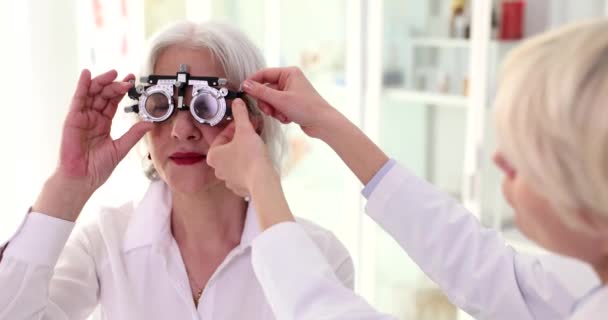 Doctor Ophthalmologist Putting Glasses Checking Vision Fitting Glasses Elderly Woman — Stock Video