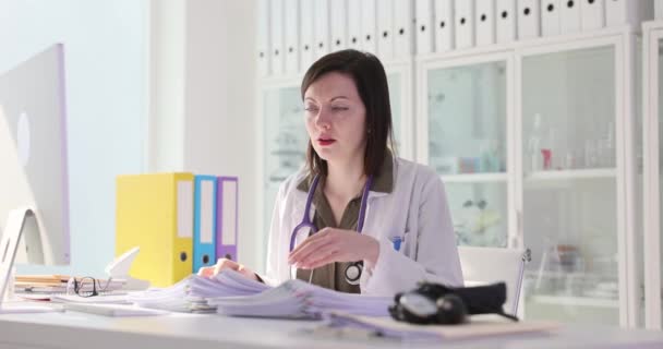 Zmęczony Smutna Kobieta Lekarz Studiuje Wiele Dokumentów Klinice Film Slow — Wideo stockowe