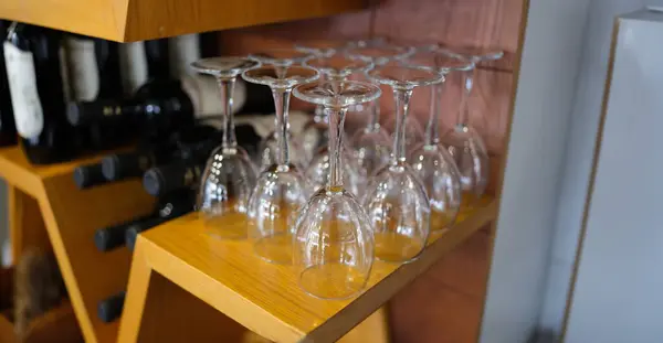 Wine bar with empty glasses and bottles of elite wine. Wine tasting and bottling